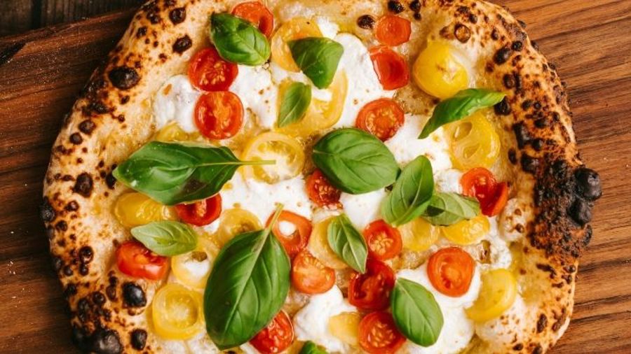 Gräddad pizza med färska tomater, basilika och burrata.